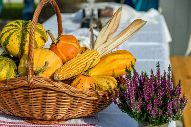 Autumn foods and decorations in basket on table